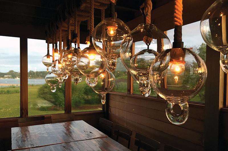 Sideman created a buoy chandelier for Beach Road Restaurant made of glass, rope, and steel.