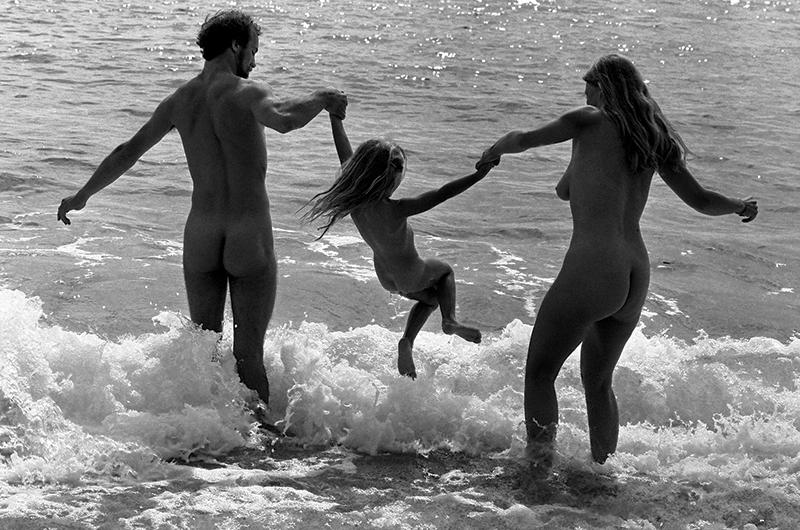 A couple swings a child at Zack’s Cliffs beach in Aquinnah in 1990.