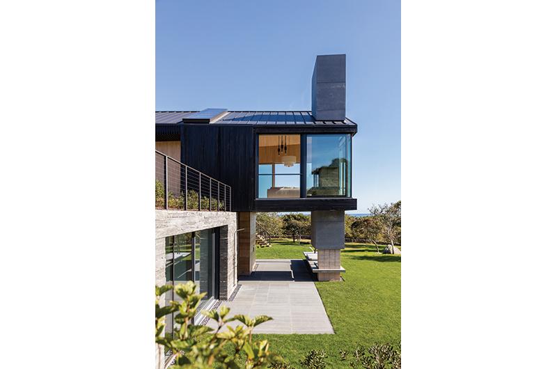 The home’s jet-black exterior is inspired by the Japanese process called Shou-Sugi-Bahn, which roughly translates to “burnt cedar siding.”