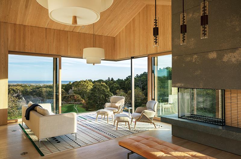 Giant walls of sliding glass in the living room provide stunning views of Chilmark Pond and the Atlantic Ocean.