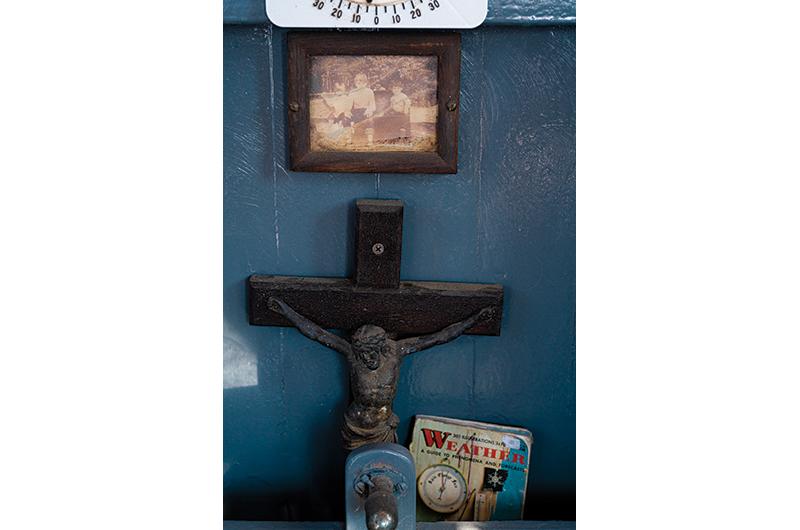 His grandfather’s crucifix sits near the helm for good luck.