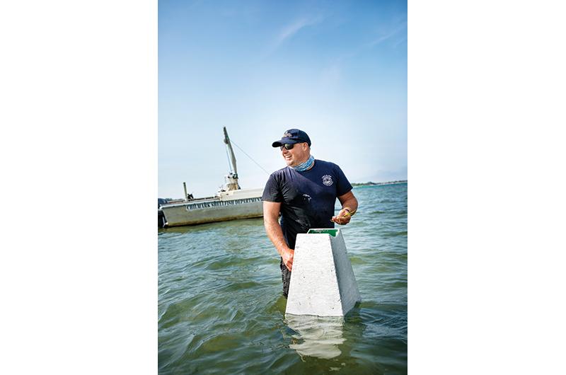 Chilmark shellfish constable Isaiah Scheffer surveys eelgrass in Menemsha Pond.