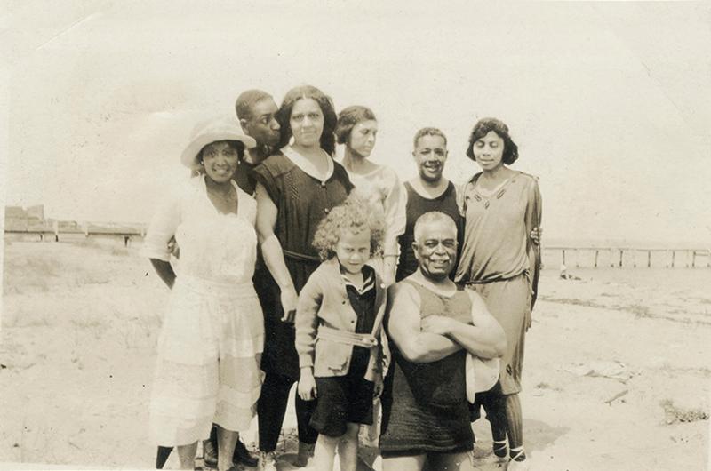 This 1930s Oak Bluffs beach photo includes members
of the Shearer family with
some inn guests and friends. In front is a young Doris Jackson, who later ran the inn, and beloved guest
Harry T. Burleigh.