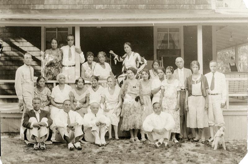 The Shearer family gathered on the cottage porch in 1931; the venerable Charles Shearer stands third from the right.