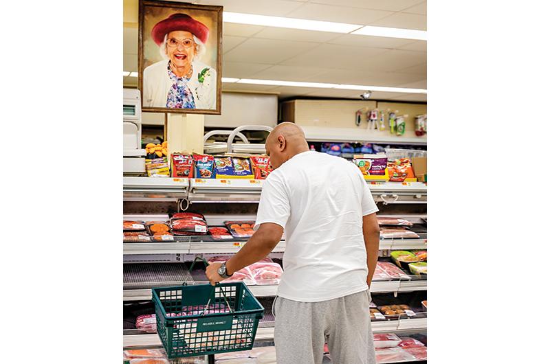 A portrait of the late Helen Pacheco watches over Reliable Market.