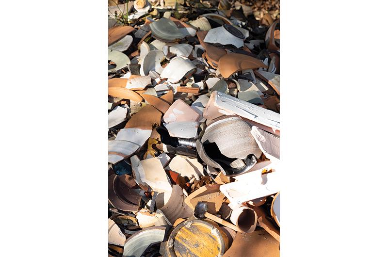The shard pile features smashed, finished pieces that did not pass muster.