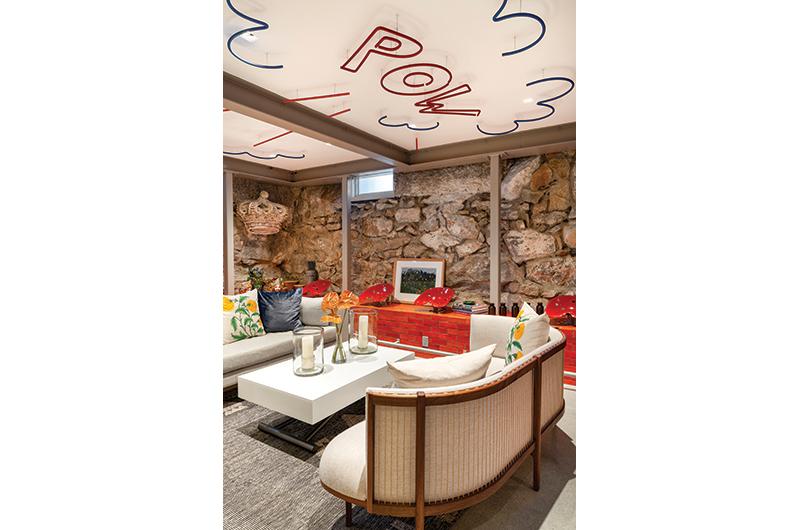 The original stone and cement walls are visible in the basement, which was renovated as a place to entertain.