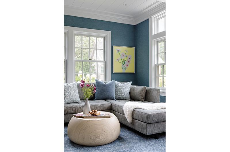 The family room gets a pop of color from textured vinyl wallpaper.