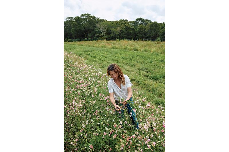 Krishana Collins gathering flowers she will sell at the farmers' market.